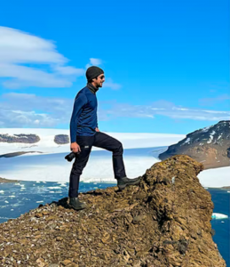 Sebastian Modak posed atop a peak on Devil Island © Sebastian Modak/Lonely Planet
